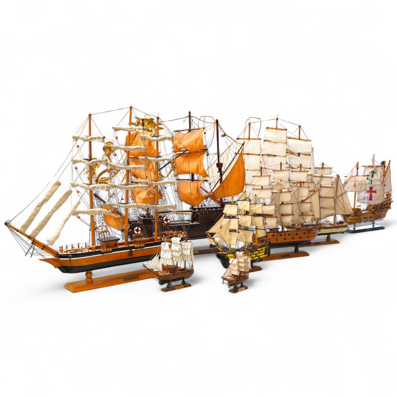 A collection of ten wooden models of famous ships including; the Cutty Sark, HMS Victory, the Mayflower, Revenge, and Santa Maria, largest 125cm wide